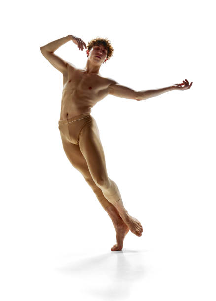 ballet dance steps. young athletic man dressed beige leggings training dance moves against white studio background. - motion art naked studio shot imagens e fotografias de stock