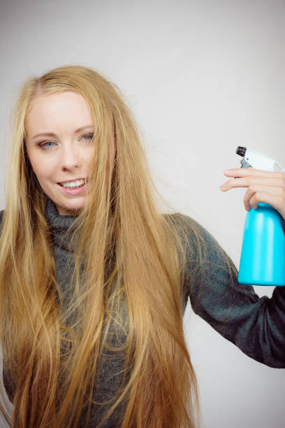 istock Female messy long hair holds spray bottle 1962751621