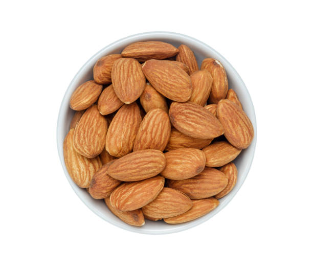 istock Ceramic bowl of almonds isolated on white background.with clipping path. top view. 1962761660