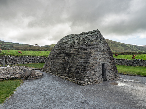 The Gallarus Oratory is a well-known historical site located on the Dingle Peninsula in County Kerry, Ireland. It is a remarkably well-preserved Christian church that is believed to date back to the 7th or 8th century. The oratory is made of dry stone construction, with a corbelled roof that resembles an upturned boat. The structure is often referred to as a beehive hut due to its distinctive shape.