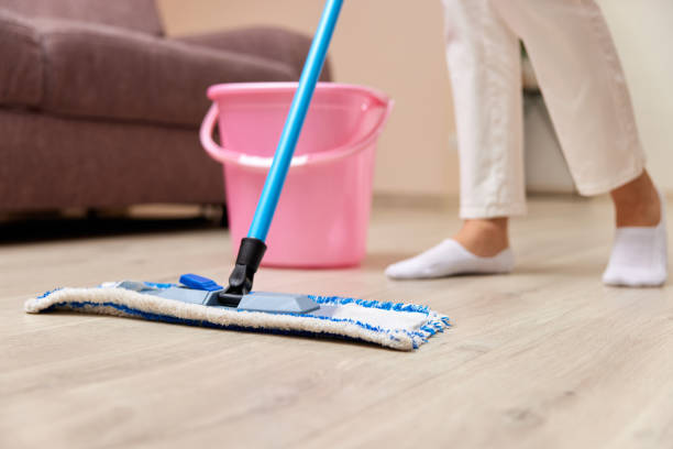 istock young woman mopping floor at living room 1962773036