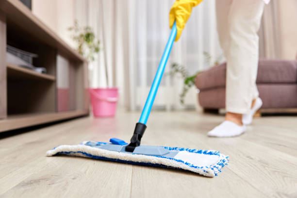 istock young woman mopping floor at living room 1962773049