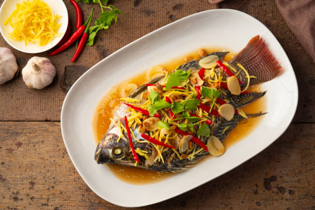 istock Steamed Tilapia fish with Soybean Paste sauce in white plate. 1962792374