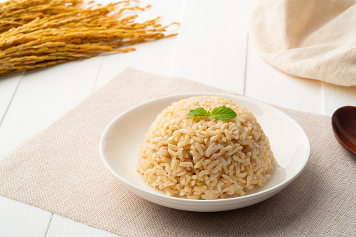Cooked brown Jasmine rice in a plate.milled rice imperfectly cleaned.Healthy food.