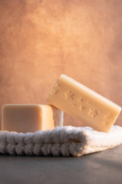 istock Soap stacked on a white wash cloth illuminated by a golden light. 1962831917