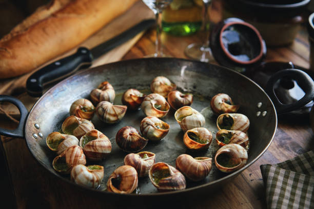 istock Preparing French Escargot Snails with Herb Butter 1962840436
