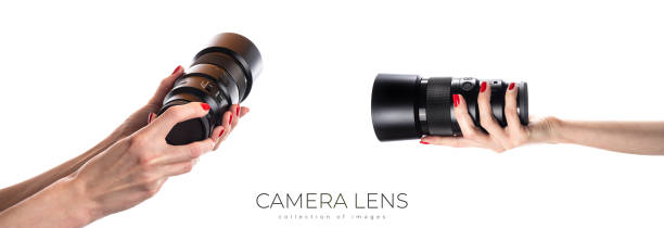 Camera lens isolated. Hand holding camera lens in hands isolated on white background. High quality photo