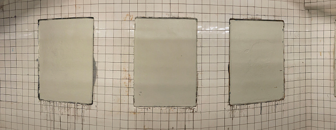 wide angle view of empty poster supports in a subway station, Brooklyn, New York