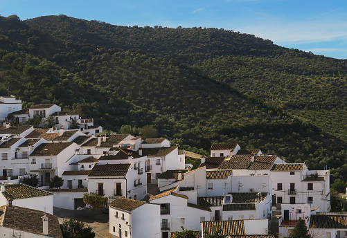 elevated view of houses in Grazalema, a village in the province of Cadiz, one of the White Villages of Andalusia,  in the foothills of the Sierra del Pinar mountain range, Spain