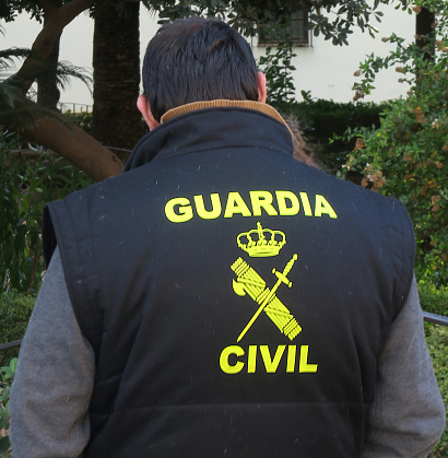 a member of Spain's Guardia Civil patrolling a public plaza in Ronda,  Spain