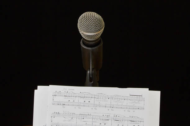 Single microphone on shiny blue background.