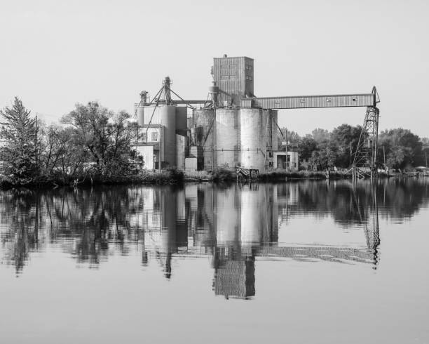 istock a large grain elevator in the middle of a lake next to trees 1962875566
