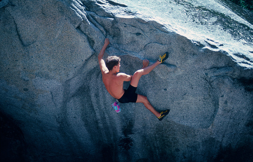 young man bouldering in Yosemite Valley, California, USA