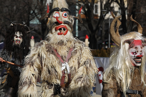 Pernik, Bulgaria - January 26, 2024: International masquerade festival Surva in Pernik, Bulgaria. People with mask called Kukeri dance and perform to scare the evil spirits.