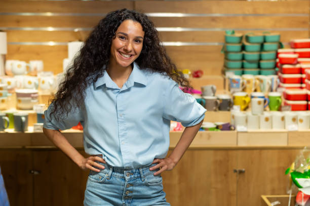 Confident young entrepreneur posing proudly in a quaint home d cor shop