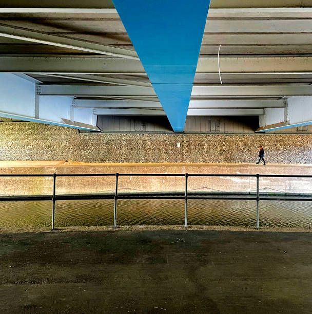 Stockholm, Sweden Oct. 15 2024 A man walks in silhouette through an urban passage.