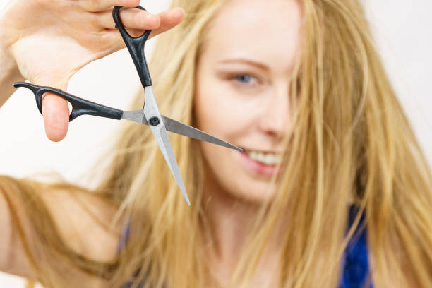 istock Woman with scissors ready to hair cutting 1962981577
