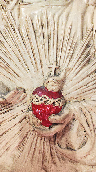 red sacred heart of jesus, white statue closeup