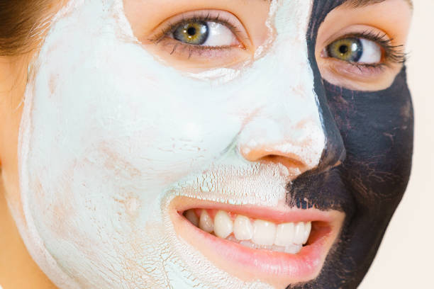 istock Girl with black white mud mask on face 1962990468