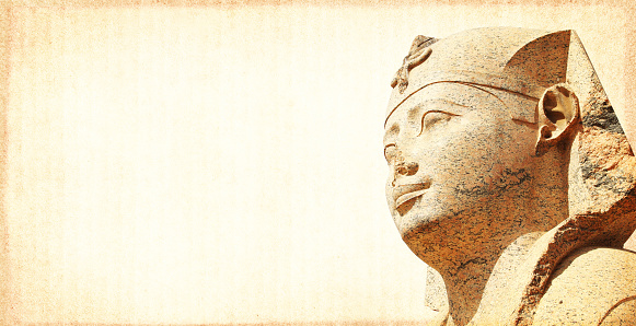 Grunge background with paper texture and face of sphinx statue. Horizontal banner with ancient egyptian sphinx in Alexandria. Copy space for text. Mock up templat