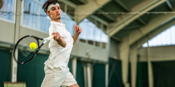 istock Male tennis player hitting ball with racket 1963010663