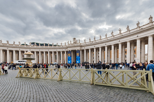 Vatican City, Vatican - December 29, 2023: Street atmosphere in San Pietro Square (Saint Peter's Square) where tourists are walking on a winter day in bad weather