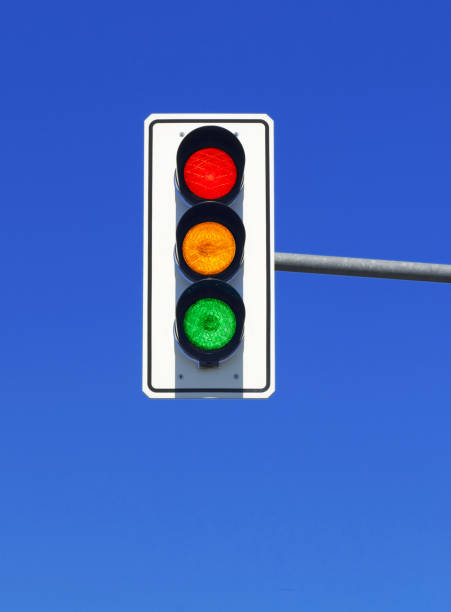 istock traffic light in blue sky with red, yellow and green lights on 1963025455