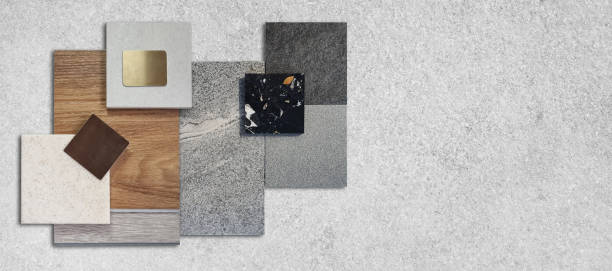 istock top view composition of interior material samples including stone granite tiles, terrazzo, wooden vinyl flooring tile, gold stainless, quartz placed on grey concrete table with blank space for design. 1963031881