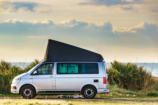 Van with roof top tent camping on nature