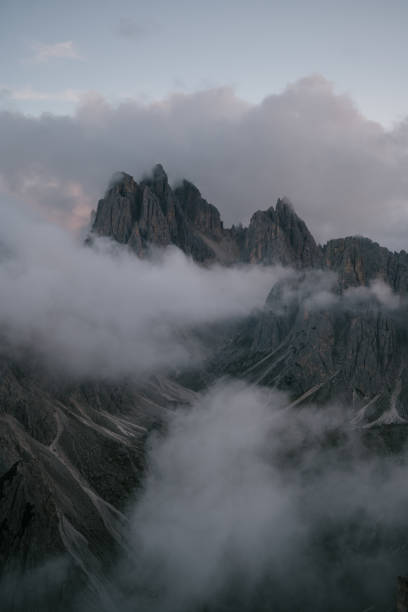 istock Peaceful scenery of sharp cliffs and mountain peaks reaching the clouds. Perfect tourist spot in Trentino valley 1963038430