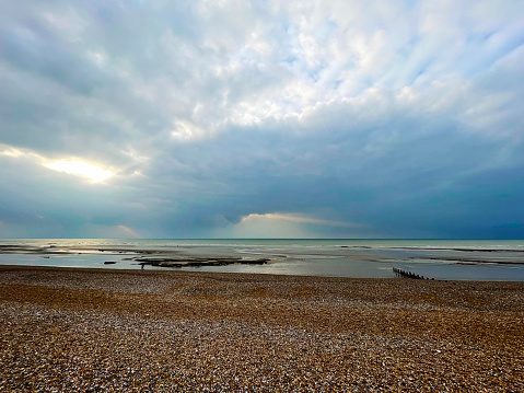 Dramatic clouds on the  beach at Bexhill on Sea