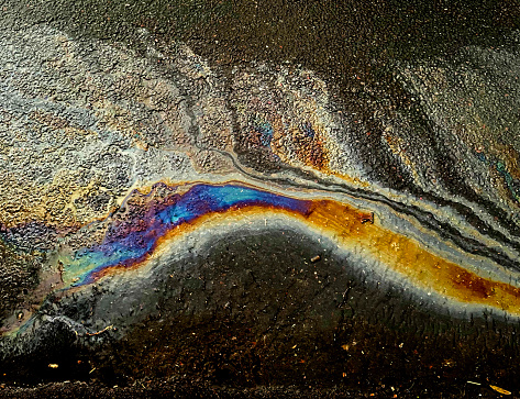 Abstract oil spill on wet tarmac