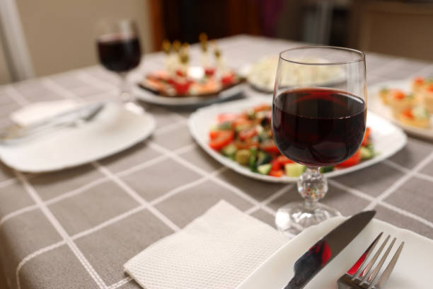 istock Festively laid table with glasses of red wine. 1963069409