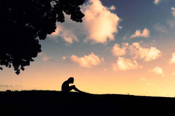 istock Lonely sad little boy in the park at sunset. 1963076323