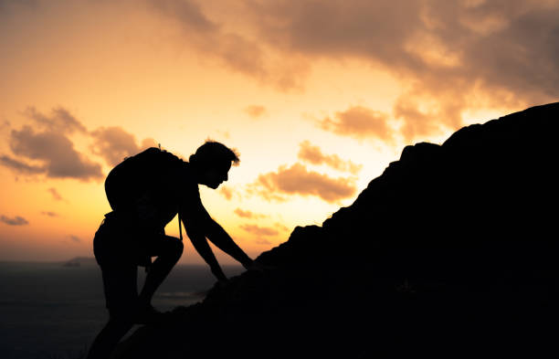 istock Senior man climbing up the mountain. 1963076857