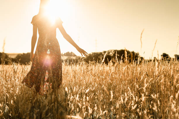istock Woman enjoying sunset in the meadow, 1963078943
