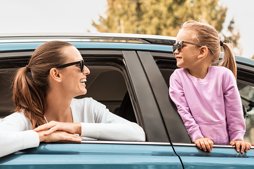 Mother and daughter having fun at the road trip.