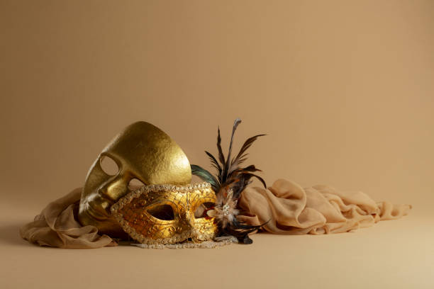 istock Golden Venetian carnival masks on a beige background. 1963081532