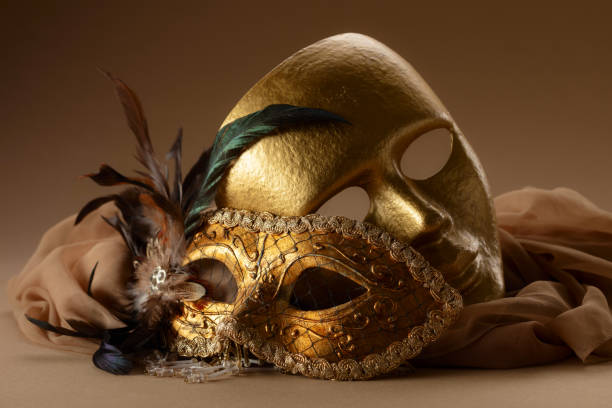 istock Golden Venetian carnival masks on a beige background. 1963081534