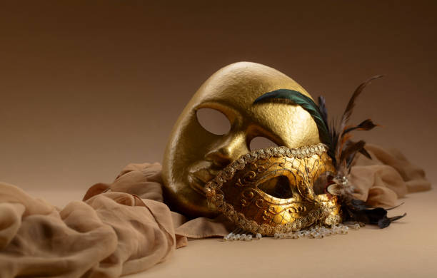 istock Golden Venetian carnival masks on a beige background. 1963081536