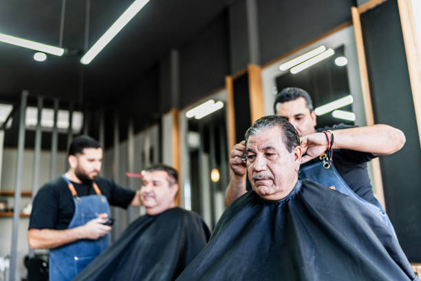 istock Barber cutting his customer hair at barber shop 1963084672