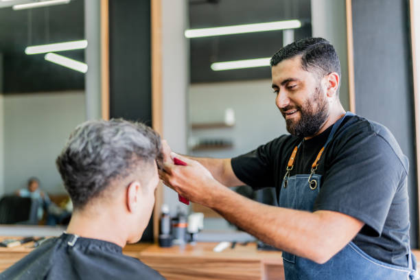 istock Barber cutting customer hair at barber shop 1963116295