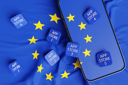 Phone showing EU flag and app store app icons scattered on the national flag of European Union. Illustration of the concept that EU customers are allowed to download apps from different app stores