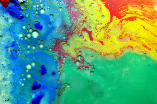 A textured pattern created by paints diluted in a liquid with bubbles.