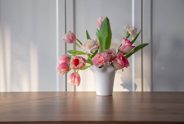 istock pink spring flowers in white ceramic vase in modern home interior 1963190340