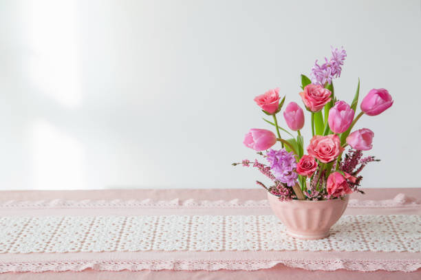 istock pink flowers in vase on background white wall 1963190860