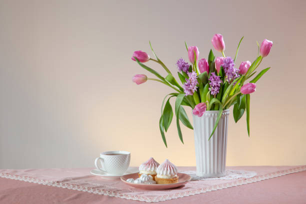 istock cup of tea and cupcakes with spring flowers in light colors 1963191055