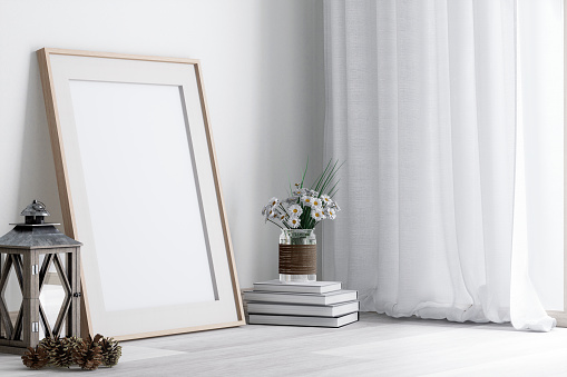 Empty picture frame made of wood Place it on the floor against the wall next to a window with white curtains in a bright room 3d render, Decorated with vintage style lanterns and flower vases.