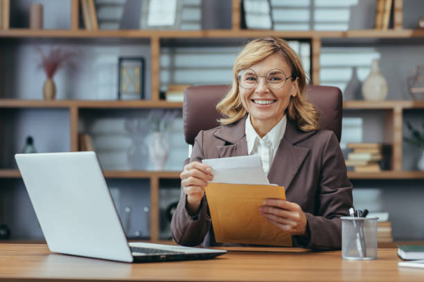istock Confident senior businesswoman working from home office with technology 1963214643