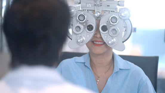 Middle-aged woman cutting farsightedness in an optical shop